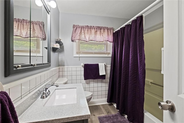 13223 Gammon Rd, Lees Summit, MO 64086 - full bath with toilet, healthy amount of natural light, vanity, wood finished floors, and a wainscoted wall