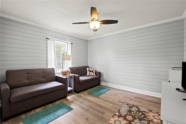 13223 Gammon Rd, Lees Summit, MO 64086 - living area featuring ornamental molding, a textured ceiling, a ceiling fan, wooden walls, and wood finished floors
