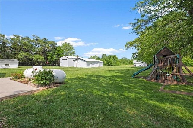 13223 Gammon Rd, Lees Summit, MO 64086 - view of grassy yard with a playground and an outbuilding