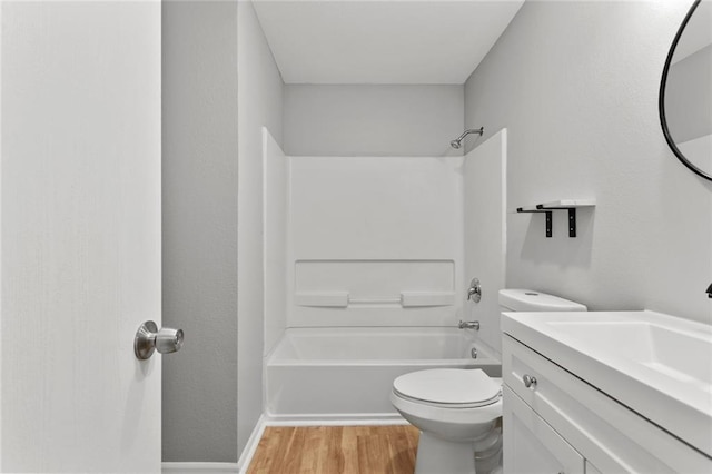 1506 W 25th Ct Unit E5, Lawrence, KS 66046 - bathroom with wood finished floors, toilet, shower / bathtub combination, vanity, and baseboards
