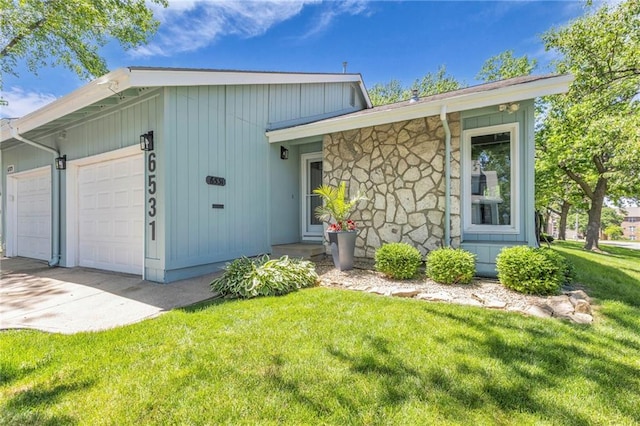 6531 W 49th St, Mission, KS 66202 - view of front of house with a garage, a front yard, and concrete driveway