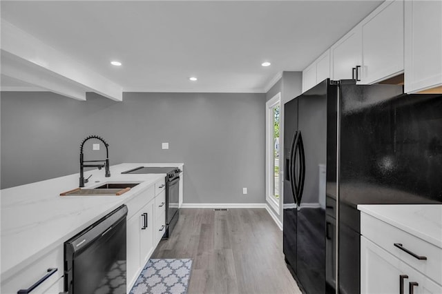 6531 W 49th St, Mission, KS 66202 - kitchen featuring black appliances, a sink, light wood-type flooring, light stone countertops, and white cabinetry