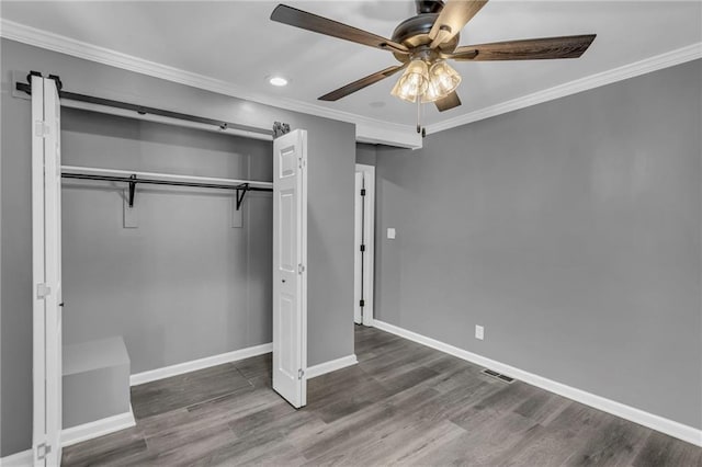 6531 W 49th St, Mission, KS 66202 - unfurnished bedroom featuring a closet, baseboards, crown molding, wood finished floors, and recessed lighting