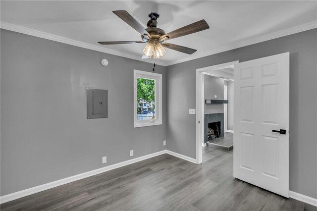 6531 W 49th St, Mission, KS 66202 - spare room with electric panel, wood finished floors, a ceiling fan, baseboards, and crown molding