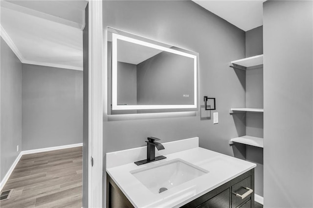 6531 W 49th St, Mission, KS 66202 - bathroom featuring wood finished floors, vanity, baseboards, and crown molding