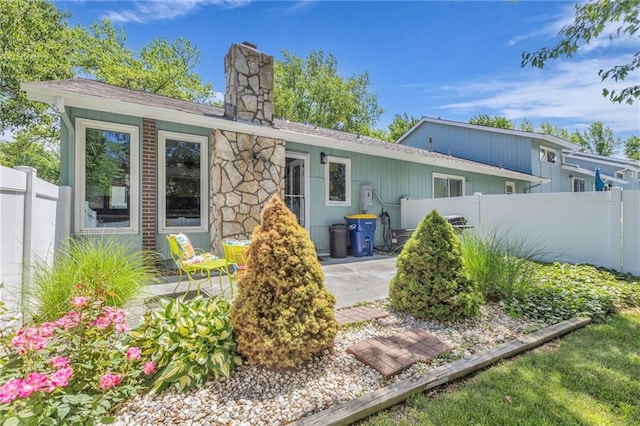 6531 W 49th St, Mission, KS 66202 - rear view of property featuring a chimney, fence, roof with shingles, and a patio