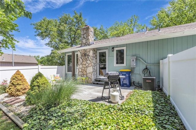 6531 W 49th St, Mission, KS 66202 - rear view of property featuring a chimney, a fenced backyard, central air condition unit, and a patio area
