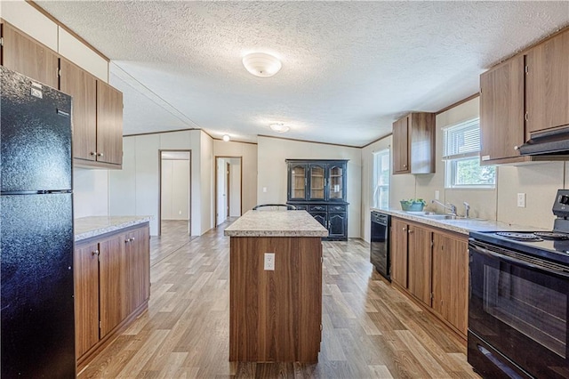 549 N Linn Valley Dr, Linn Valley, KS 66040 - kitchen with black appliances, a center island, light countertops, light wood-type flooring, and a textured ceiling