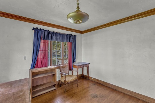 sitting room featuring hardwood / wood-style floors, ornamental molding, and baseboards