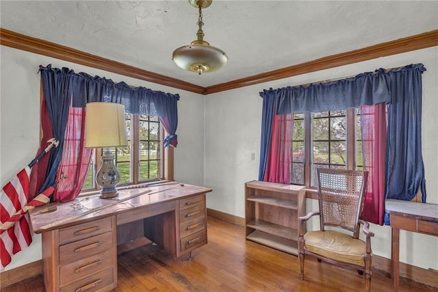 office featuring wood finished floors, crown molding, and baseboards
