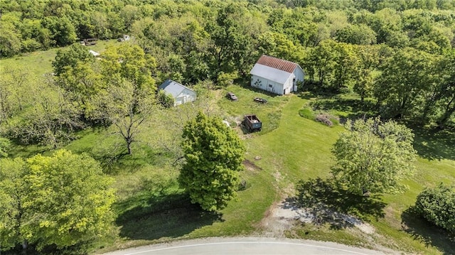 view of subject property featuring a heavily wooded area