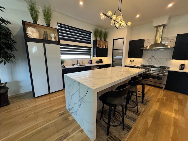 8890 Mccoy St, Lenexa, KS 66227 - kitchen with high end stove, dark cabinets, island exhaust hood, a kitchen island, and recessed lighting
