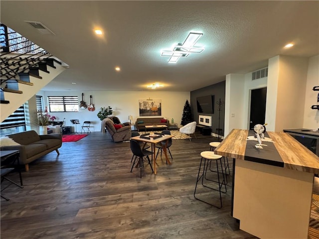 8890 Mccoy St, Lenexa, KS 66227 - dining room with dark wood-style flooring, stairway, a textured ceiling, recessed lighting, and baseboards