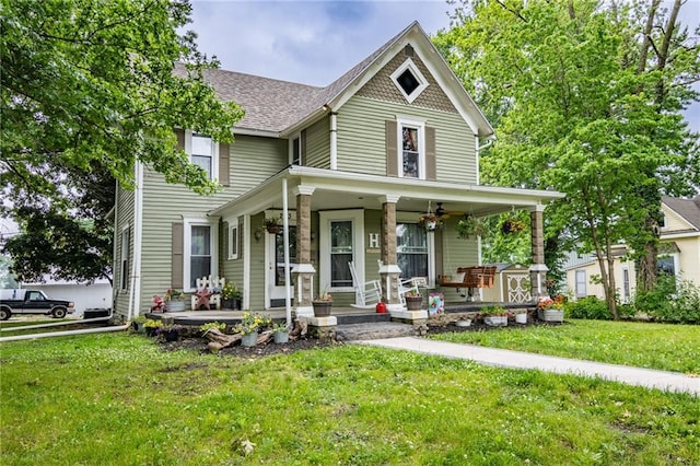 203 S Hughes St, Hamilton, MO 64644 - victorian home with covered porch, a front lawn, and roof with shingles