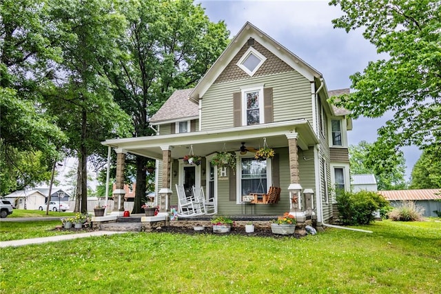 203 S Hughes St, Hamilton, MO 64644 - victorian-style house with covered porch, a front lawn, and ceiling fan