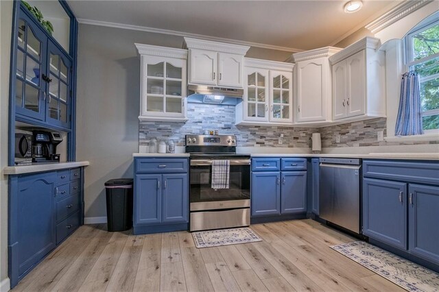 203 S Hughes St, Hamilton, MO 64644 - kitchen featuring stainless steel appliances, blue cabinetry, under cabinet range hood, white cabinets, and light wood-type flooring