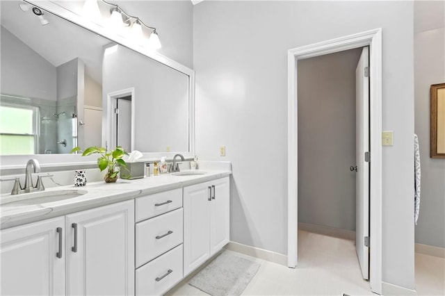 full bath with a shower with shower door, double vanity, and lofted ceiling
