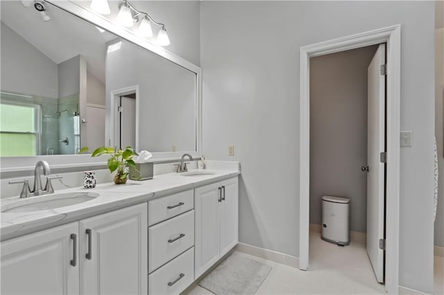 full bathroom with a shower stall, double vanity, and vaulted ceiling