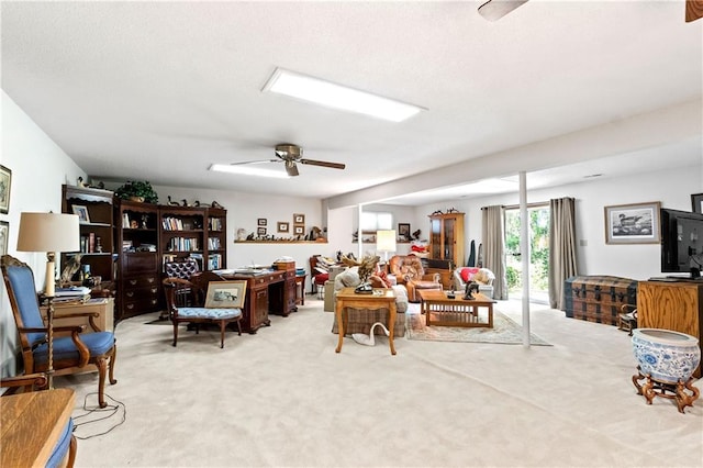 living room featuring a ceiling fan and carpet flooring