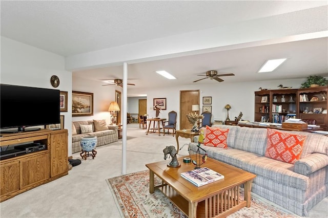 living area with ceiling fan and light carpet