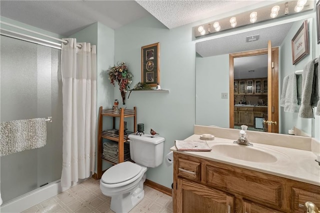 full bathroom with a shower stall, toilet, vanity, tile patterned floors, and a textured ceiling