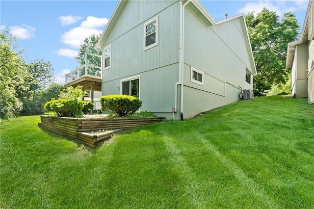 rear view of house with a yard and a deck