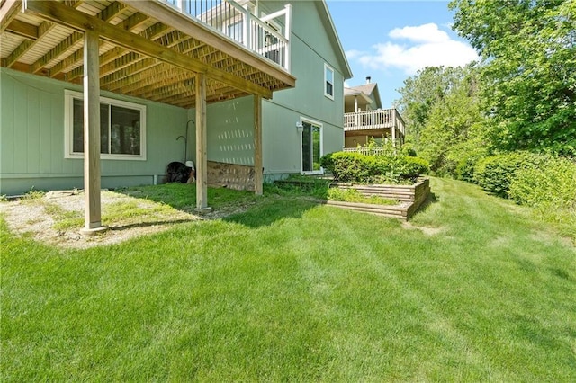 view of green lawn featuring a deck