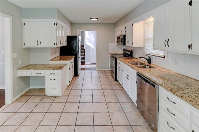 1205 SW 20th St, Blue Springs, MO 64015 - kitchen featuring appliances with stainless steel finishes, a sink, backsplash, and white cabinets