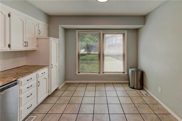 1205 SW 20th St, Blue Springs, MO 64015 - kitchen featuring dishwasher, white cabinets, decorative backsplash, light tile patterned floors, and a textured ceiling