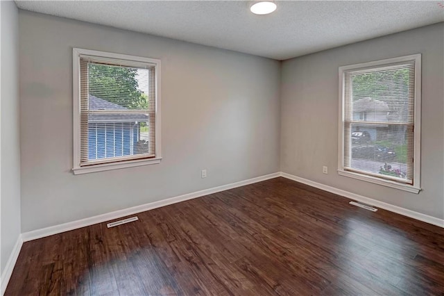 1205 SW 20th St, Blue Springs, MO 64015 - empty room with dark wood-type flooring, baseboards, and a textured ceiling