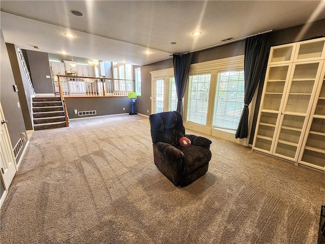 living area featuring carpet flooring, healthy amount of natural light, baseboards, stairs, and recessed lighting