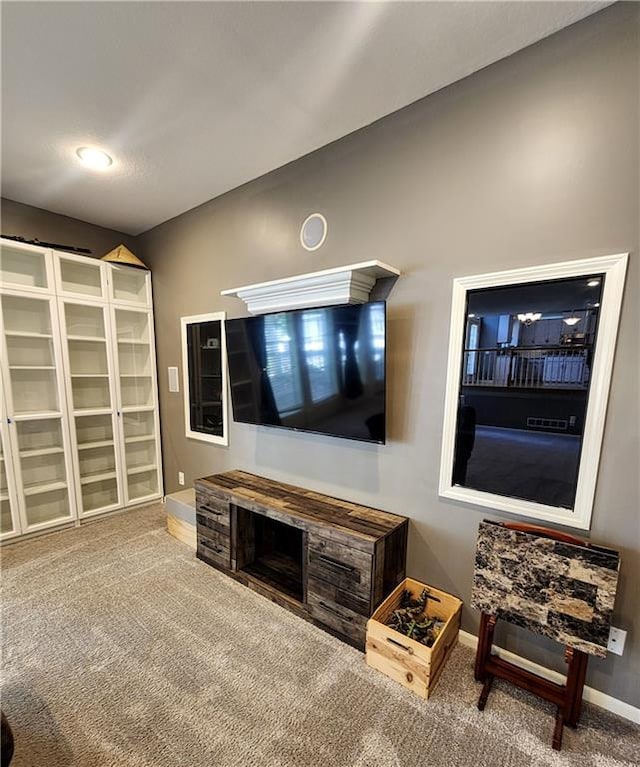 carpeted living room with baseboards