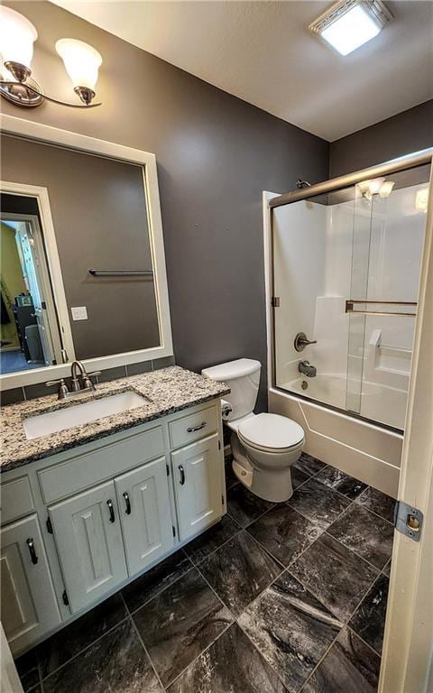 bathroom featuring vanity, toilet, and enclosed tub / shower combo
