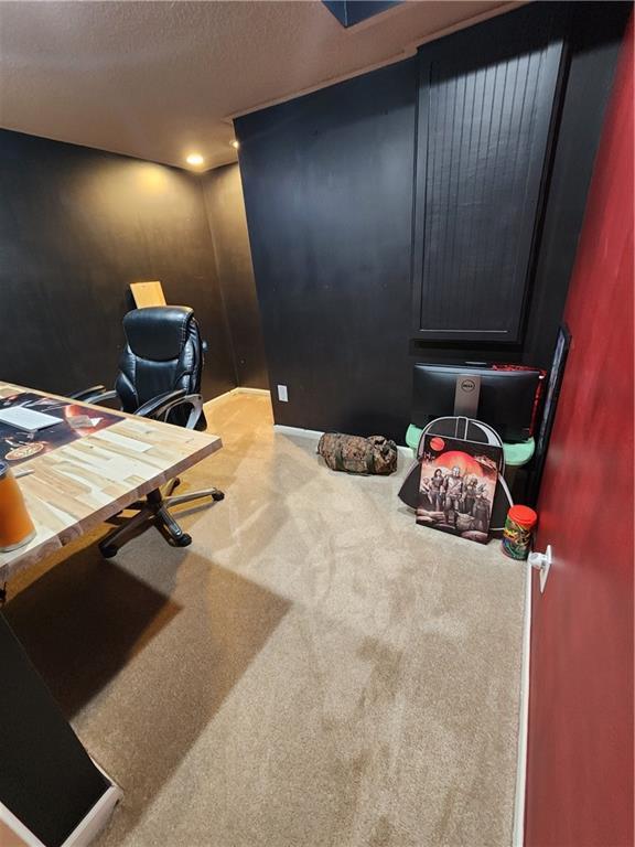 office area featuring carpet flooring and a textured ceiling