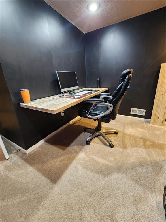 office space featuring carpet floors, a textured ceiling, and baseboards