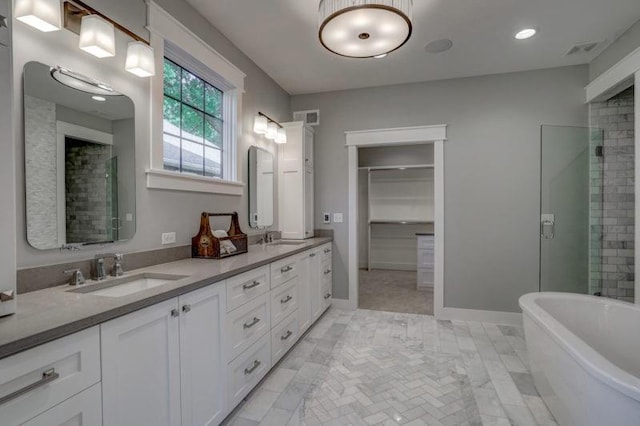 2807 W 50th Ter, Westwood, KS 66205 - full bathroom with a freestanding bath, double vanity, a walk in closet, recessed lighting, and a tile shower
