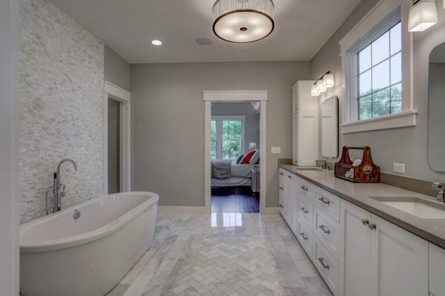 2807 W 50th Ter, Westwood, KS 66205 - ensuite bathroom featuring a freestanding tub, double vanity, and recessed lighting