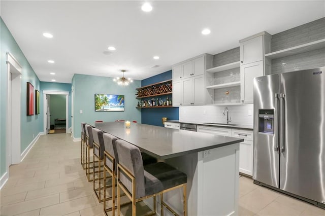 2807 W 50th Ter, Westwood, KS 66205 - kitchen with open shelves, appliances with stainless steel finishes, dark countertops, a sink, and recessed lighting