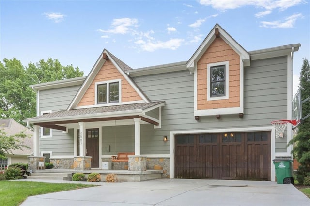 2807 W 50th Ter, Westwood, KS 66205 - craftsman-style home featuring a porch, concrete driveway, an attached garage, and stone siding