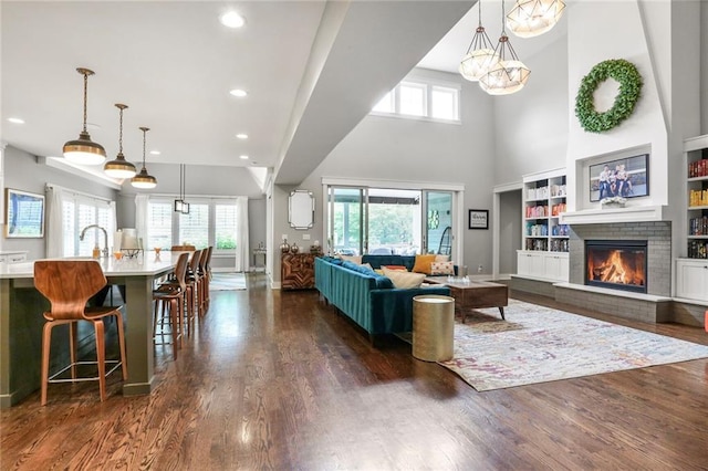 2807 W 50th Ter, Westwood, KS 66205 - living area with a fireplace, dark wood-type flooring, recessed lighting, a chandelier, and a high ceiling