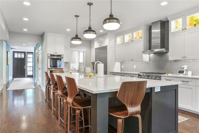 2807 W 50th Ter, Westwood, KS 66205 - kitchen featuring wall chimney range hood, recessed lighting, dark wood-style floors, backsplash, and a large island
