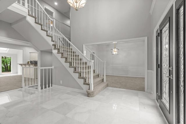 8407 W 141st St, Overland Park, KS 66223 - entrance foyer with a chandelier, a high ceiling, stairs, carpet, and a wainscoted wall