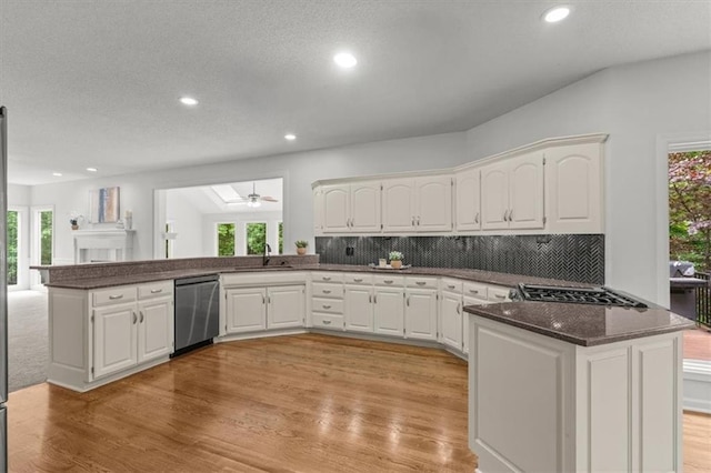 8407 W 141st St, Overland Park, KS 66223 - kitchen with a peninsula, appliances with stainless steel finishes, a ceiling fan, light wood-style floors, and white cabinets