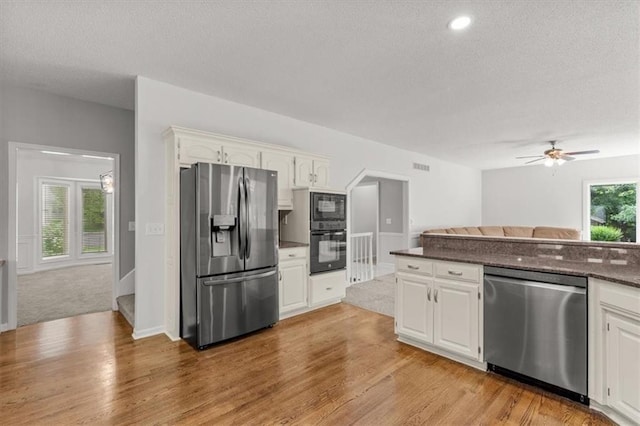 8407 W 141st St, Overland Park, KS 66223 - kitchen with black appliances, a textured ceiling, white cabinets, and light wood-style flooring