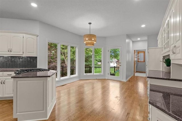 8407 W 141st St, Overland Park, KS 66223 - kitchen with healthy amount of natural light, dark stone counters, white cabinetry, and recessed lighting
