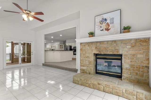 8407 W 141st St, Overland Park, KS 66223 - unfurnished living room with light tile patterned floors, ceiling fan, a glass covered fireplace, french doors, and recessed lighting