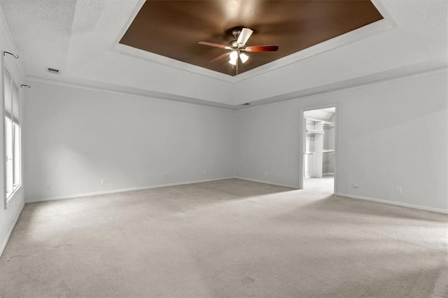 8407 W 141st St, Overland Park, KS 66223 - empty room featuring a tray ceiling, a ceiling fan, light colored carpet, and ornamental molding