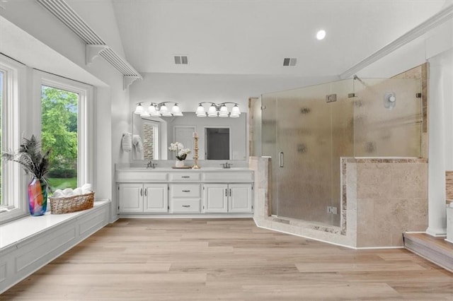 8407 W 141st St, Overland Park, KS 66223 - bathroom with double vanity, a stall shower, wood finished floors, and vaulted ceiling