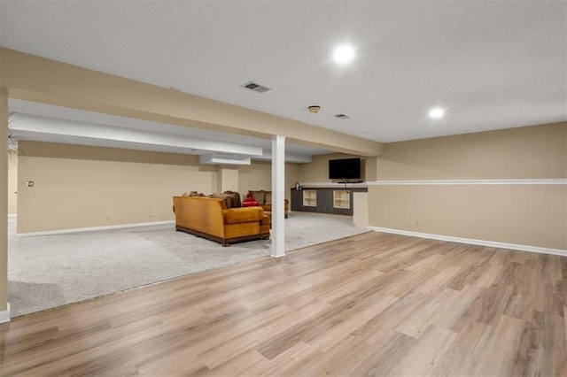 8407 W 141st St, Overland Park, KS 66223 - finished below grade area with baseboards, light wood-type flooring, a textured ceiling, and recessed lighting