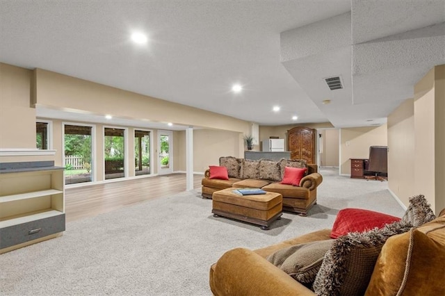 8407 W 141st St, Overland Park, KS 66223 - carpeted living area featuring recessed lighting, a textured ceiling, and wood finished floors